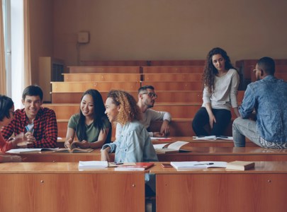 Young people sitting and talking in a lecture room