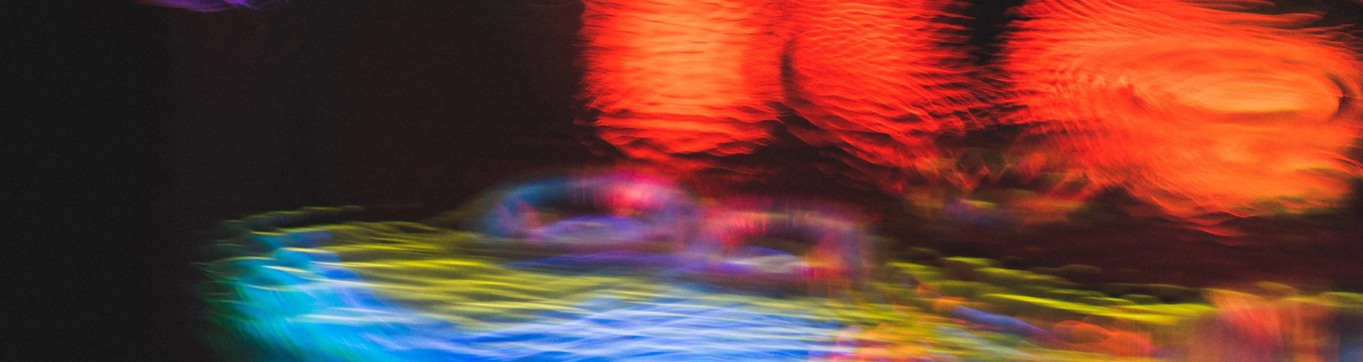 Neon light reflections in puddle