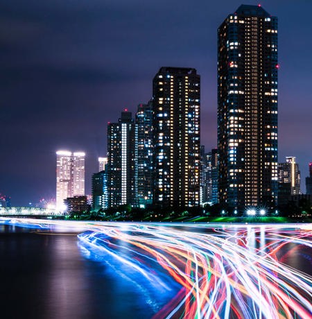 City at night with neon car trails 