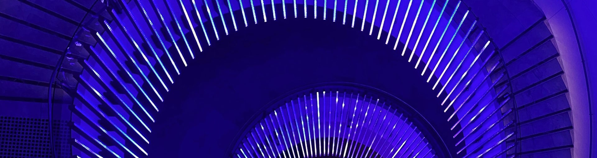 View of spiral staircase in neon blue lighting