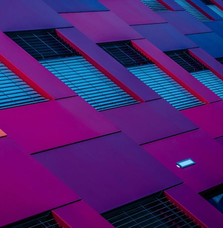 Abstract image of building with purple and blue panels and window frames